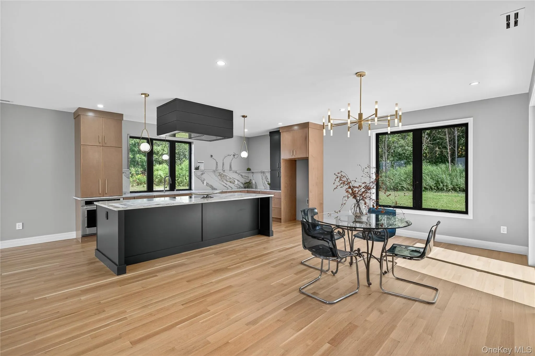 Dining area with light wood-style flooring, a chandelier, and recessed lighting Dining area with light wood-style flooring, a chandelier, and recessed lighting