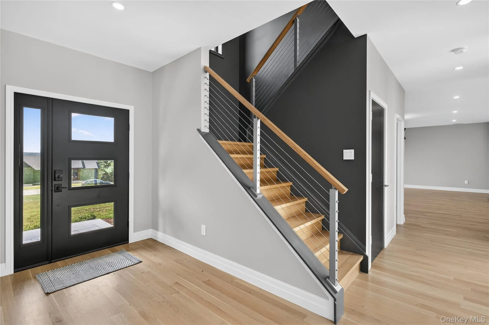 Entrance foyer with recessed lighting, light wood-type flooring, and stairway Entrance foyer with recessed lighting, light wood-type flooring, and stairway