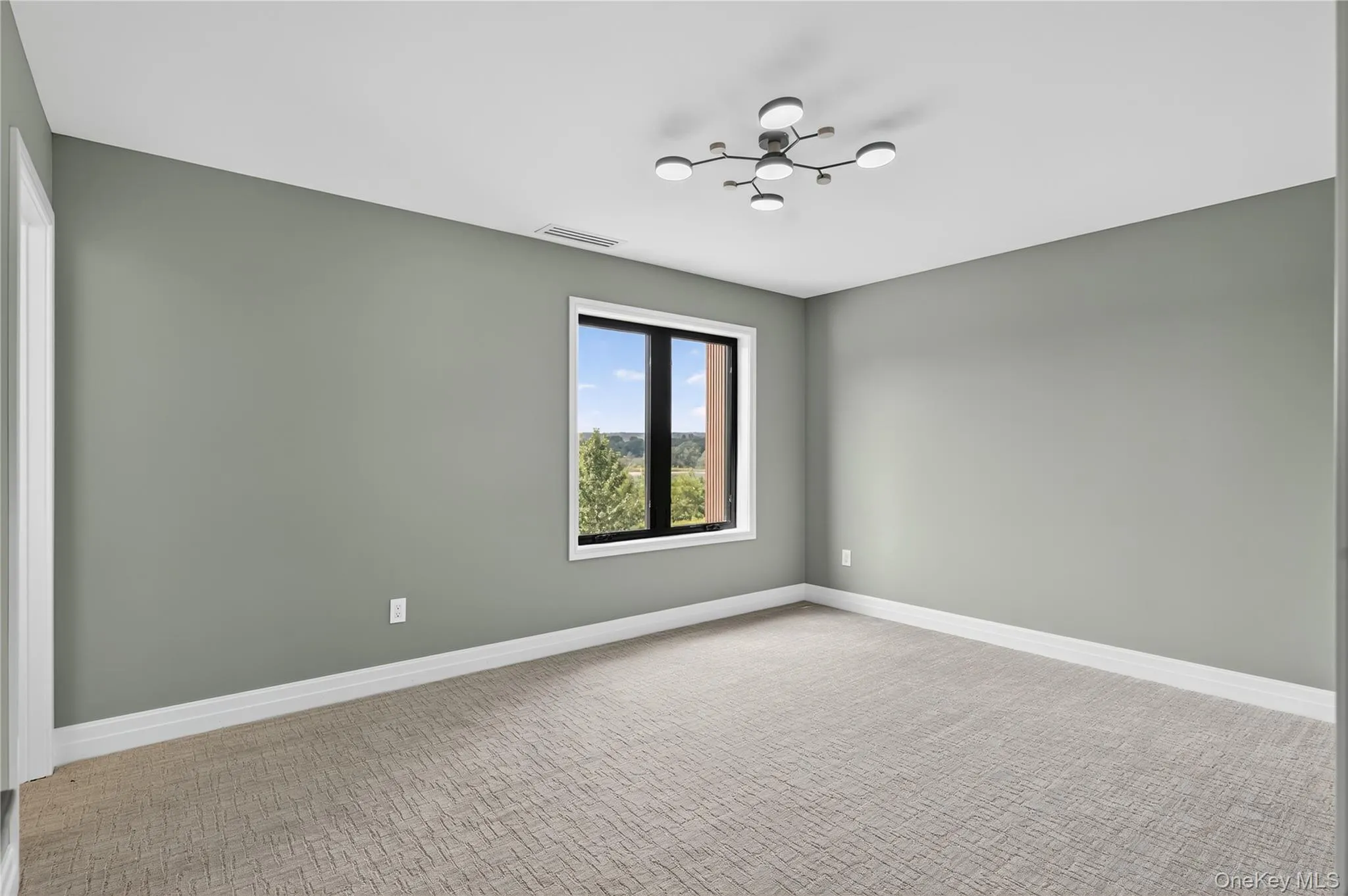 Unfurnished room featuring baseboards and light carpet Unfurnished room featuring baseboards and light carpet