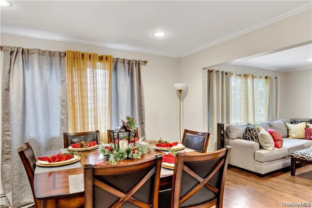 Dining room featuring crown molding, wood finished floors, and recessed lighting Dining room featuring crown molding, wood finished floors, and recessed lighting