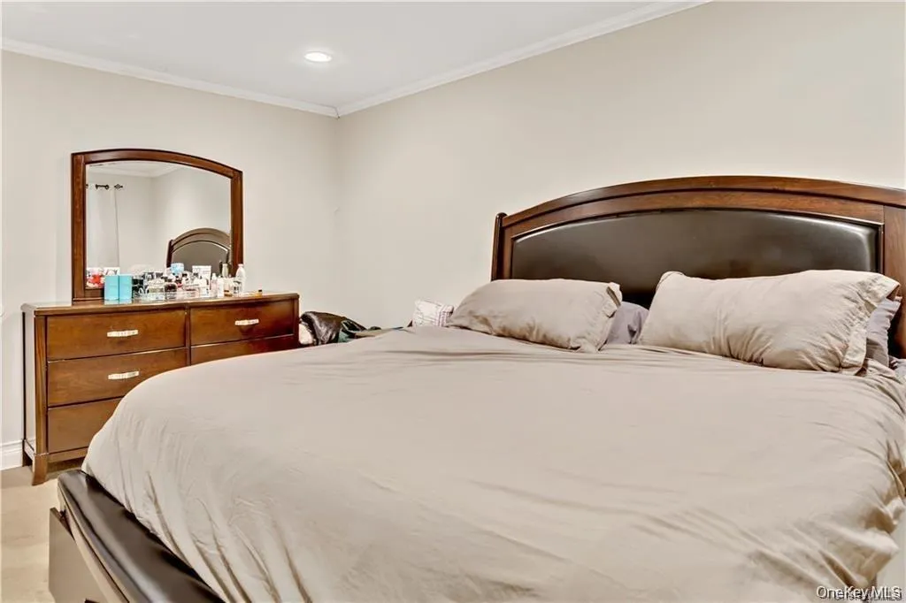 Bedroom featuring crown molding and recessed lighting Bedroom featuring crown molding and recessed lighting