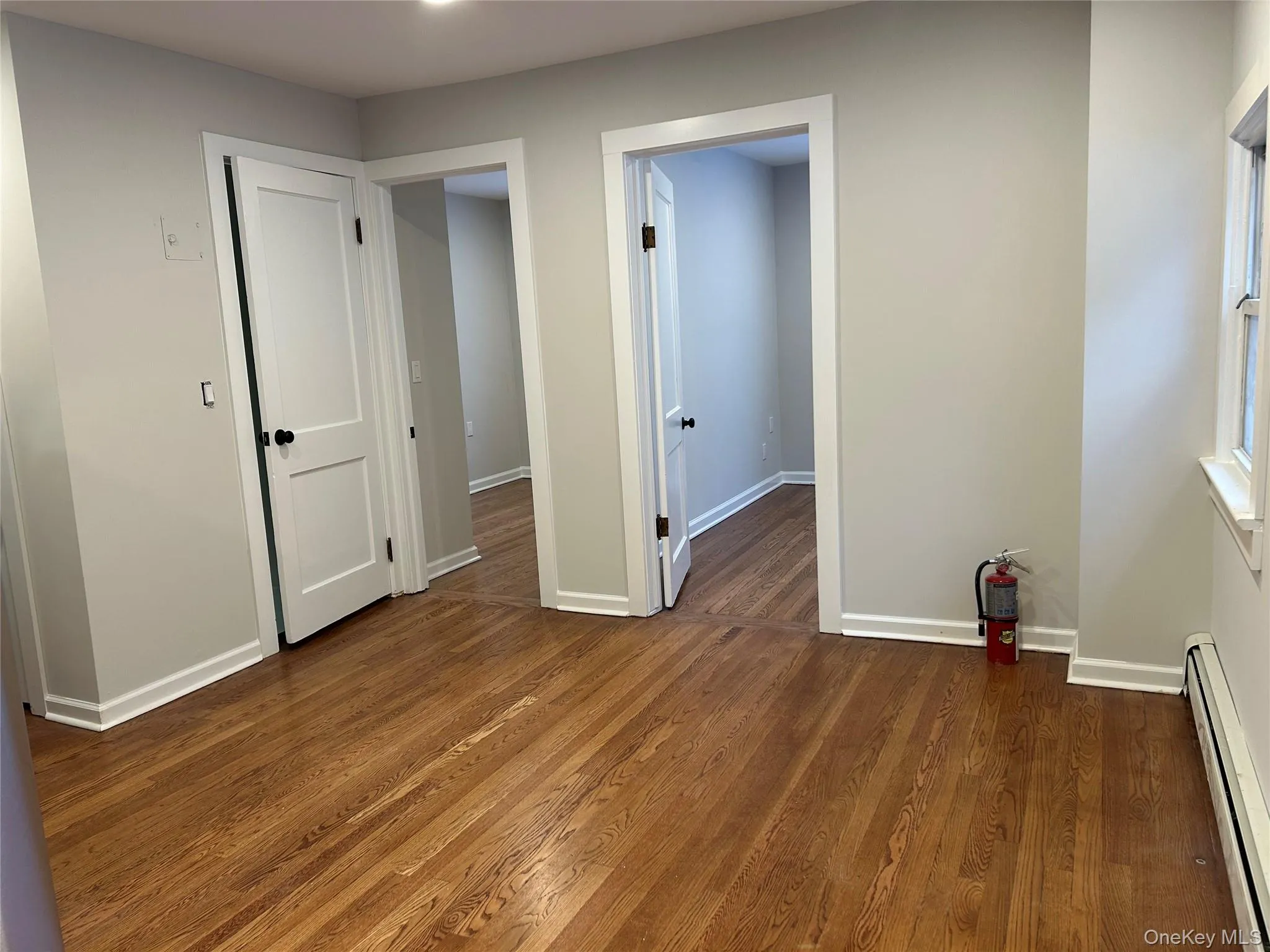 Dining area with a baseboard radiator and dark wood-type flooring Dining area with a baseboard radiator and dark wood-type flooring