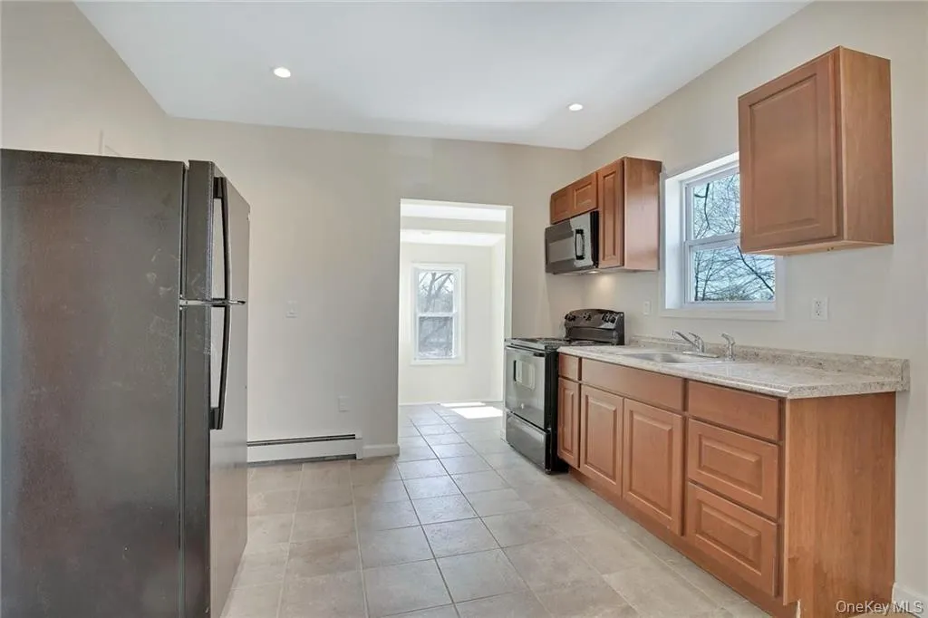 Bright kitchen with updated cabinetry, ample counter space, and a functional layout. Bright kitchen with updated cabinetry, ample counter space, and a functional layout.