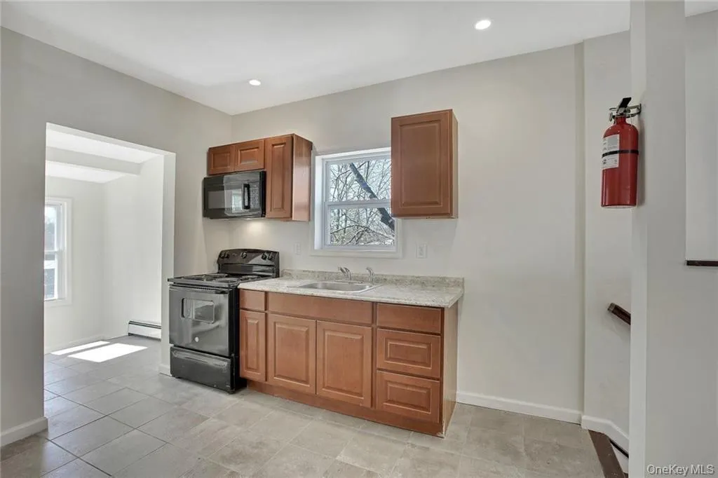 Open kitchen area with easy access to adjoining rooms—ideal for flexible living arrangements. Open kitchen area with easy access to adjoining rooms—ideal for flexible living arrangements.