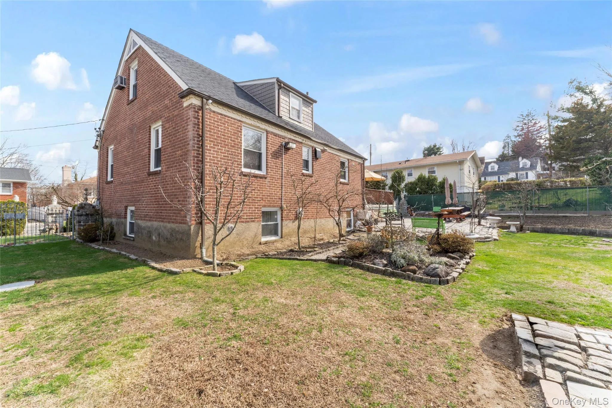 Rear view of house featuring brick siding and a patio area Rear view of house featuring brick siding and a patio area