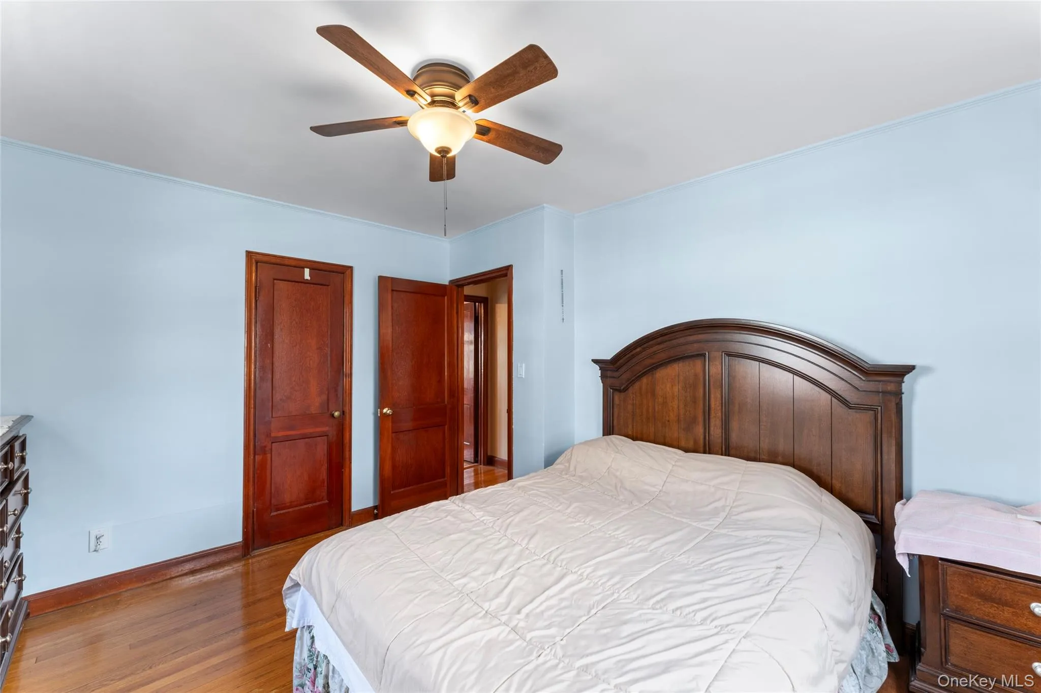 Bedroom with dark wood-type flooring and ceiling fan Bedroom with dark wood-type flooring and ceiling fan