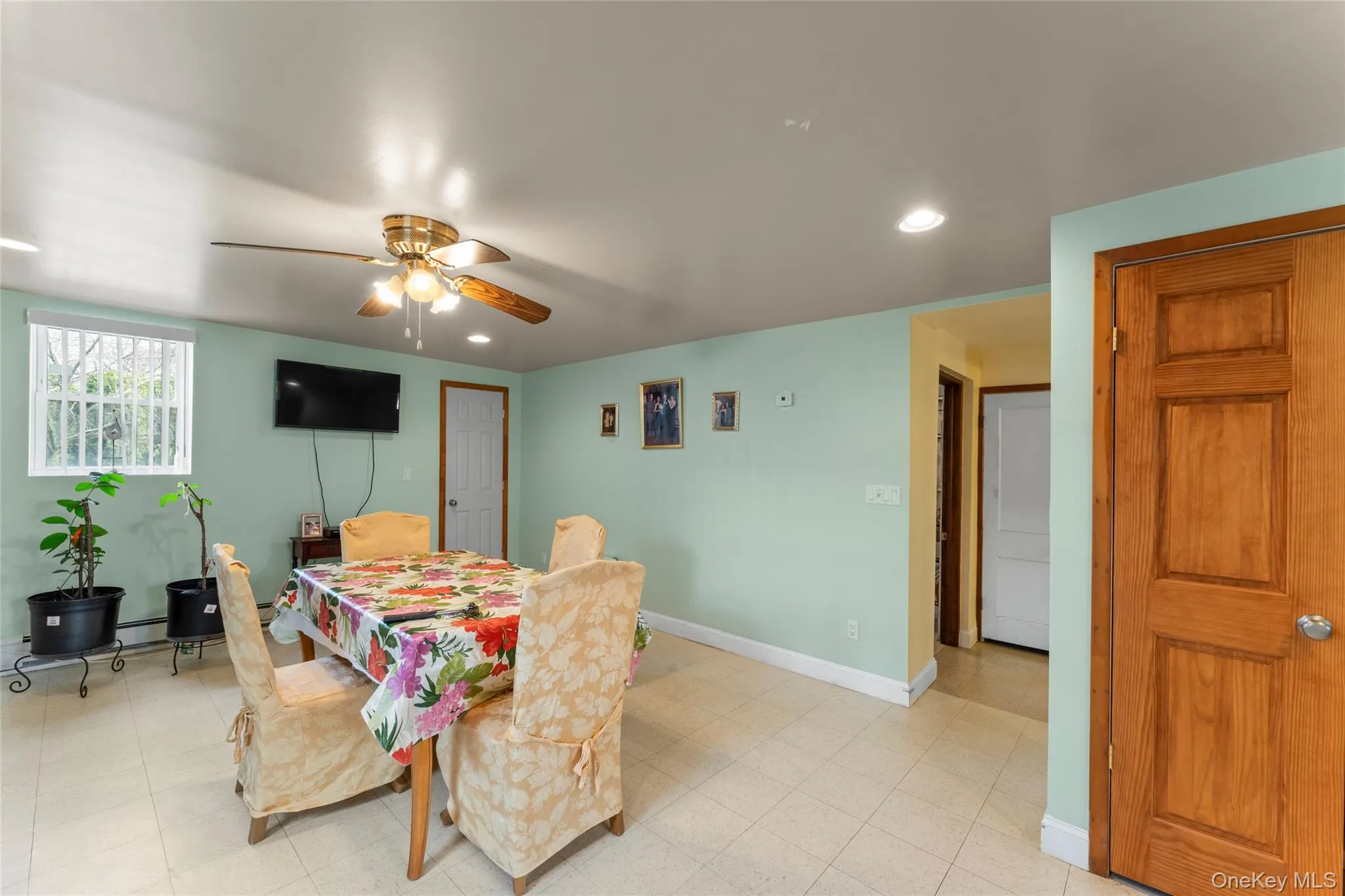 Dining space with a ceiling fan, recessed lighting, and a baseboard heating unit Dining space with a ceiling fan, recessed lighting, and a baseboard heating unit