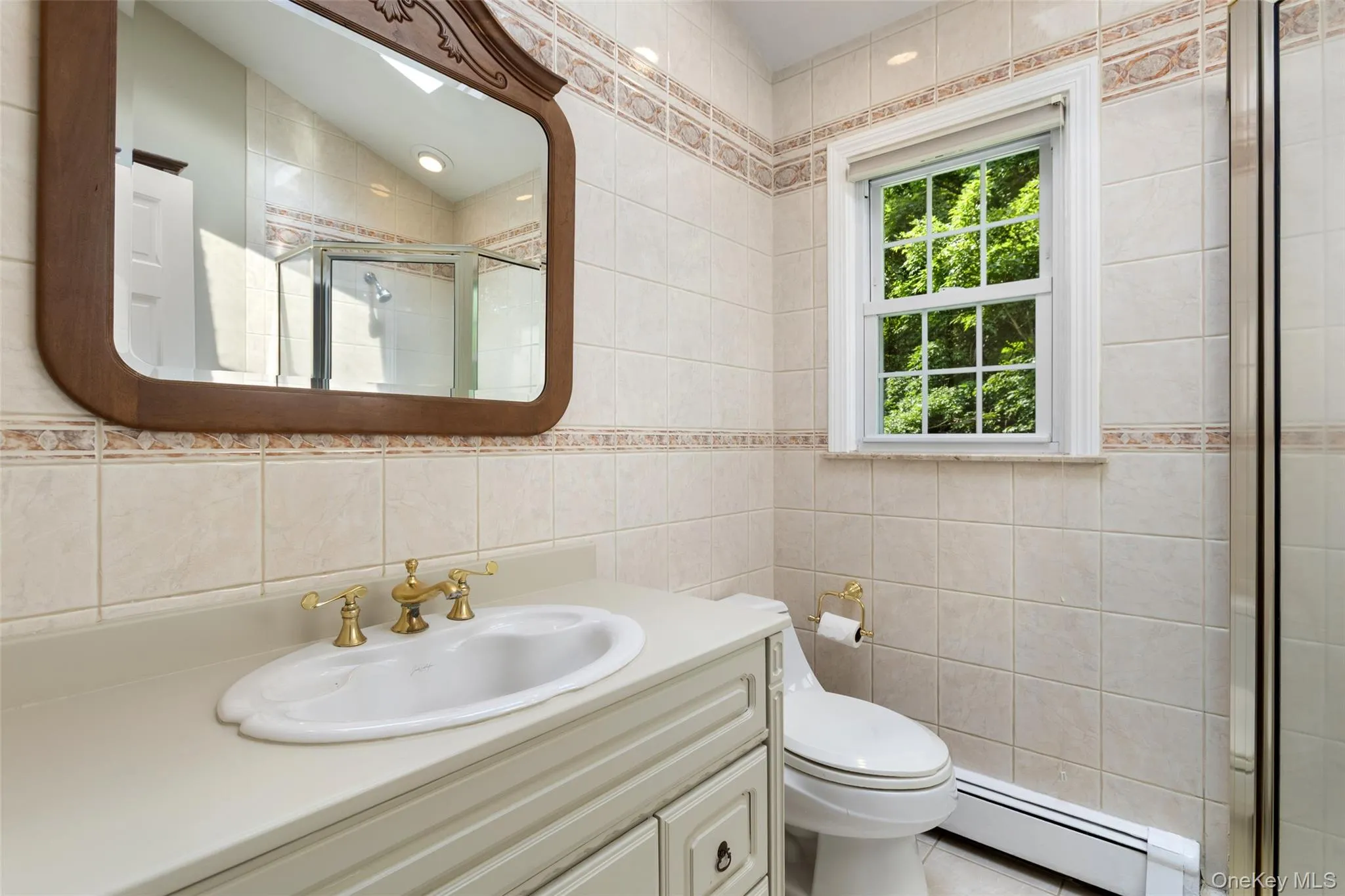 primary bathroom with vanity, window and skylight primary bathroom with vanity, window and skylight