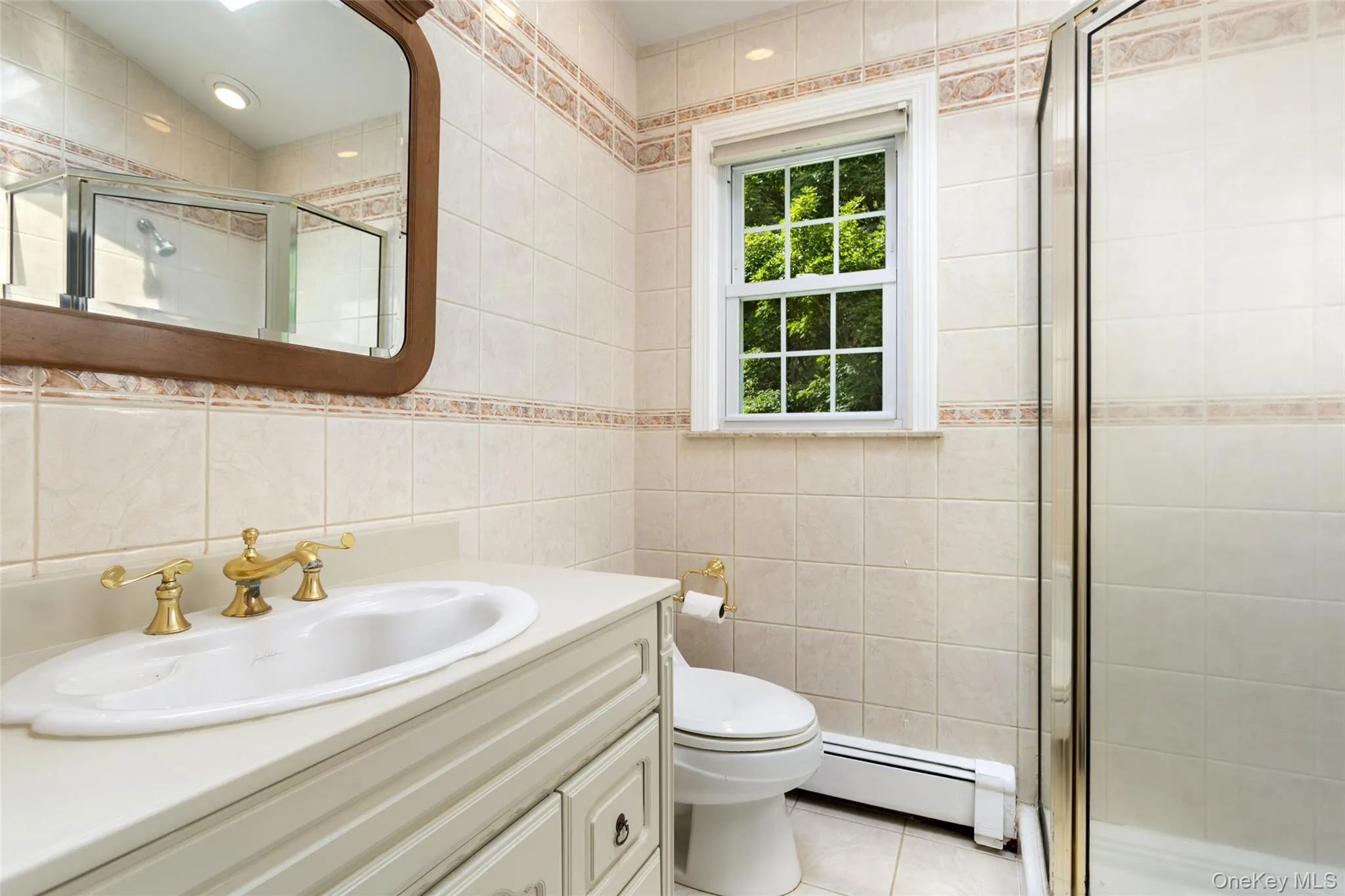 primary bathroom with vanity, window and skylight and shower stall primary bathroom with vanity, window and skylight and shower stall