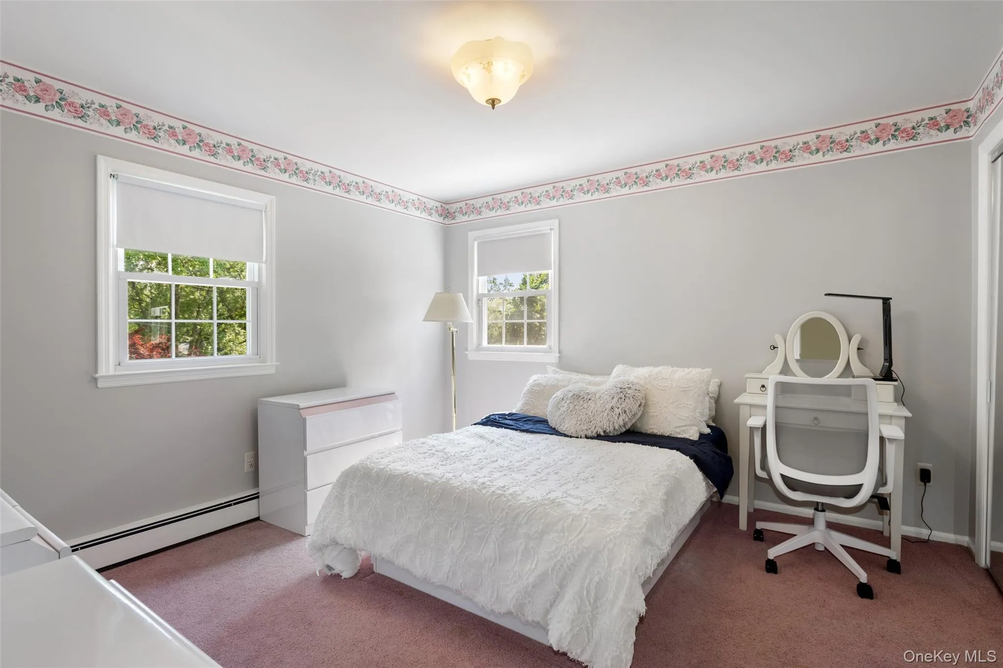 Spacious bedroom with carpeting and hardwood floors underneath Spacious bedroom with carpeting and hardwood floors underneath
