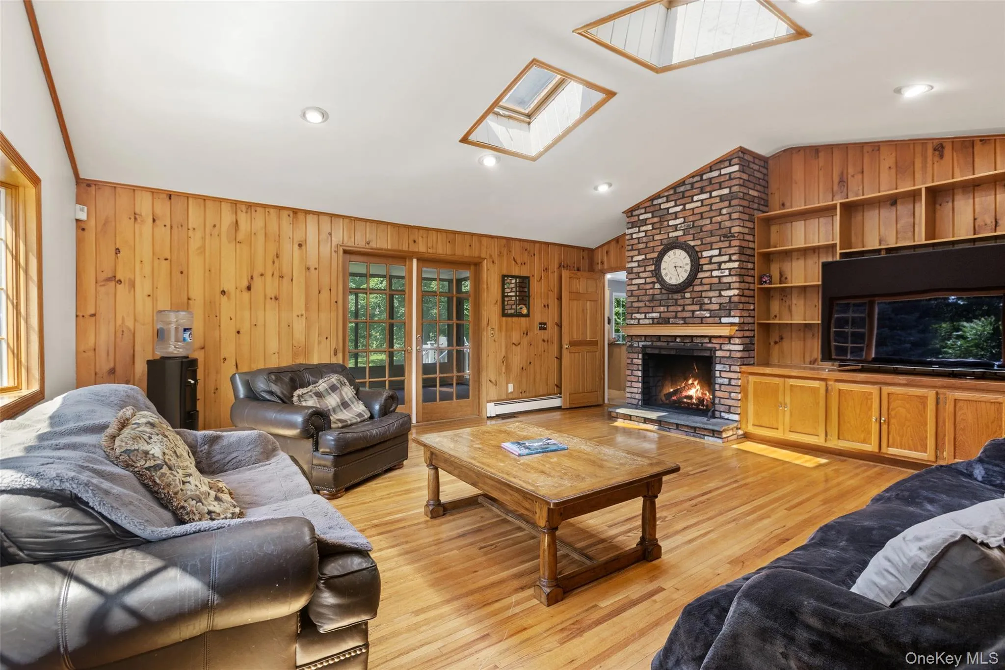 Spacious family room with brick fireplace, cathedral ceilings and skylights Spacious family room with brick fireplace, cathedral ceilings and skylights