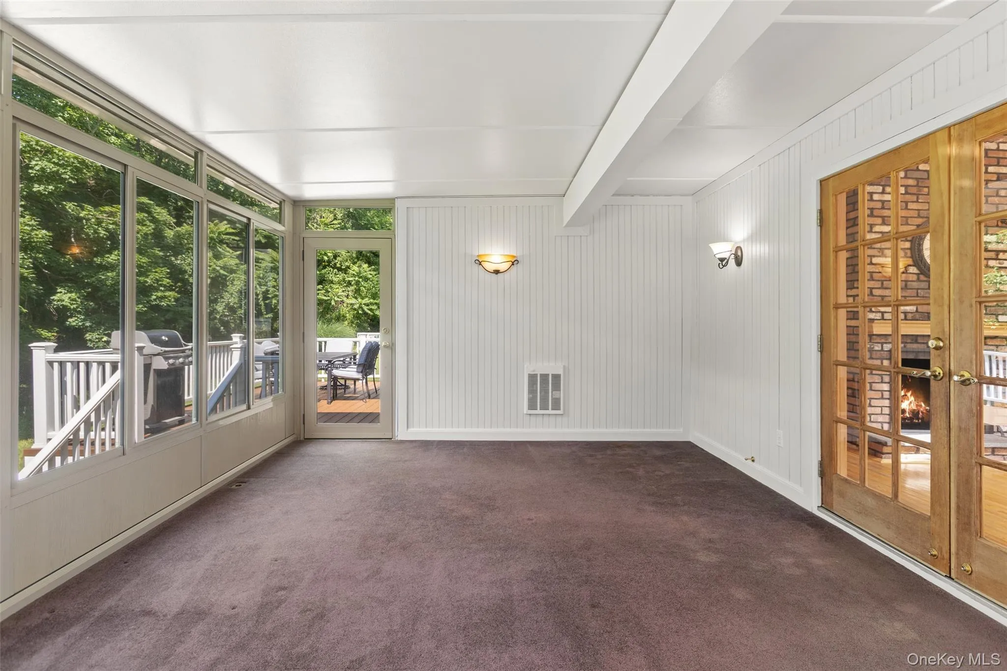 Enclosed screened in heated porch showing french doors. Enclosed screened in heated porch showing french doors.