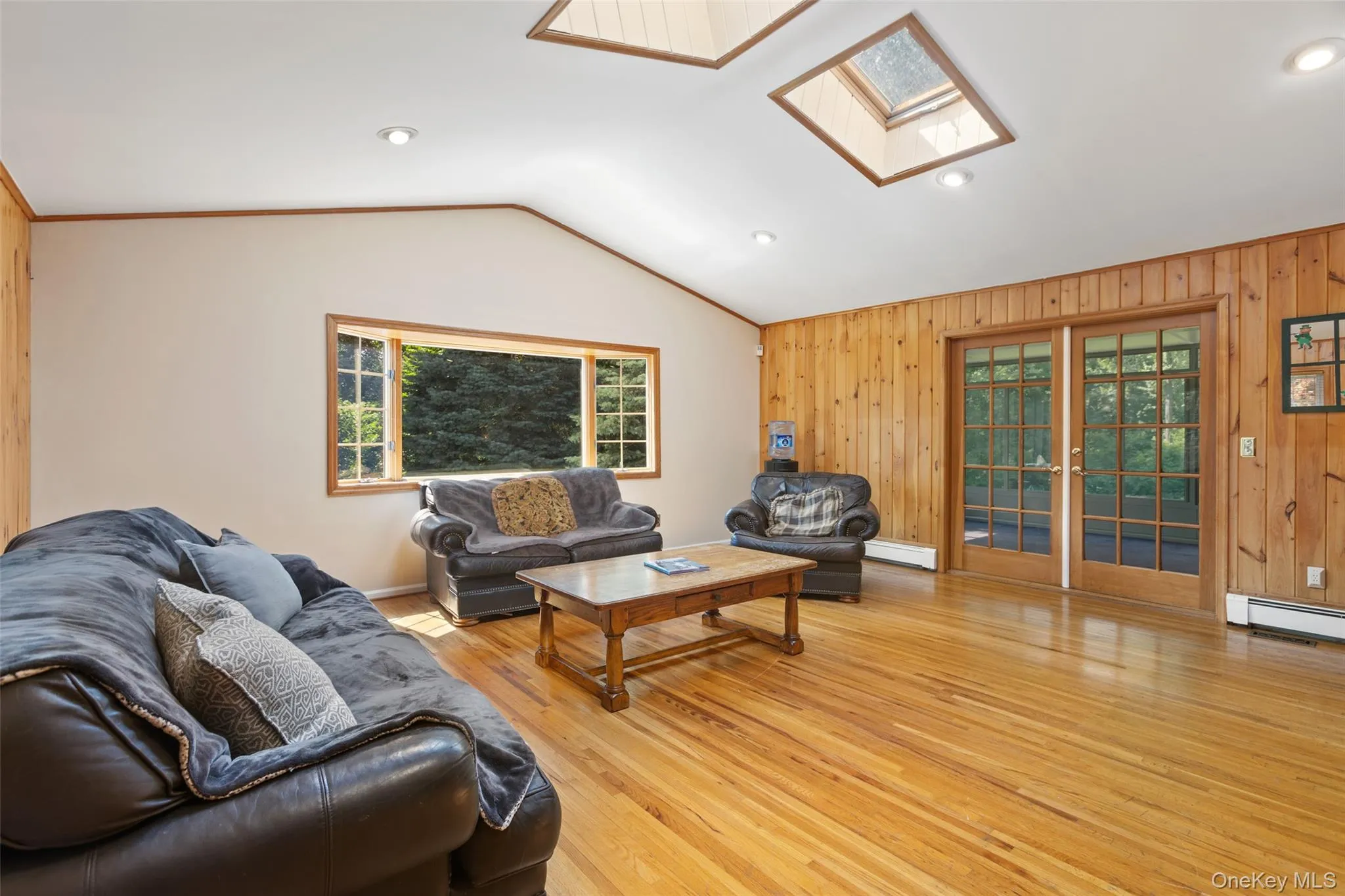 Spacious family room with cathedral ceilings, skylights and hardwood floors Spacious family room with cathedral ceilings, skylights and hardwood floors