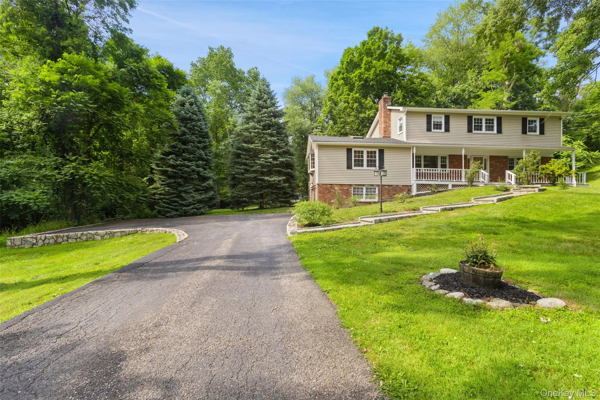Front of house showing long level driveway. Front of house showing long level driveway.