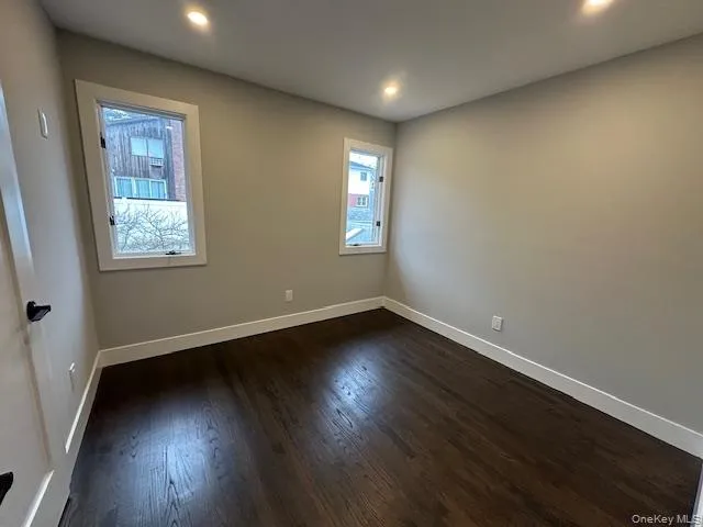 Bedroom featuring dark wood-style flooring and recessed lighting Bedroom featuring dark wood-style flooring and recessed lighting