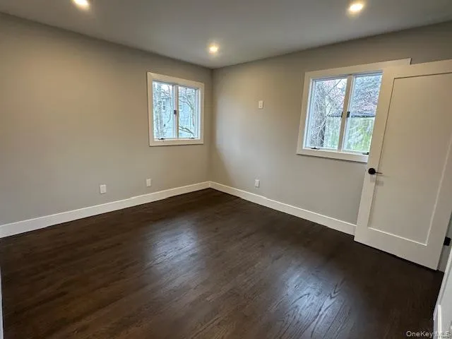 Bedroom with dark wood-type flooring and recessed lighting Bedroom with dark wood-type flooring and recessed lighting