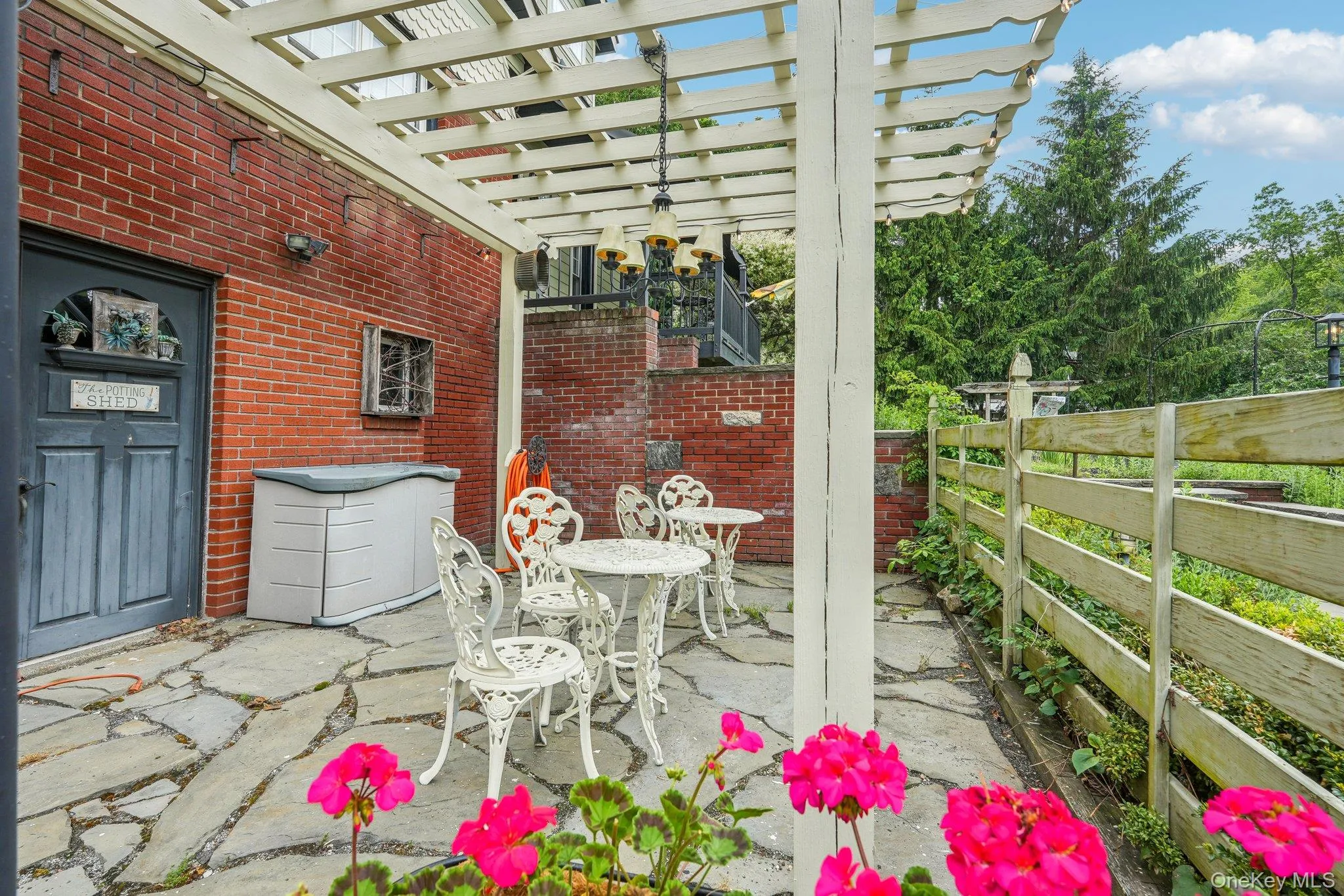 Lower level spa entrance, front of house patio and pergola Lower level spa entrance, front of house patio and pergola