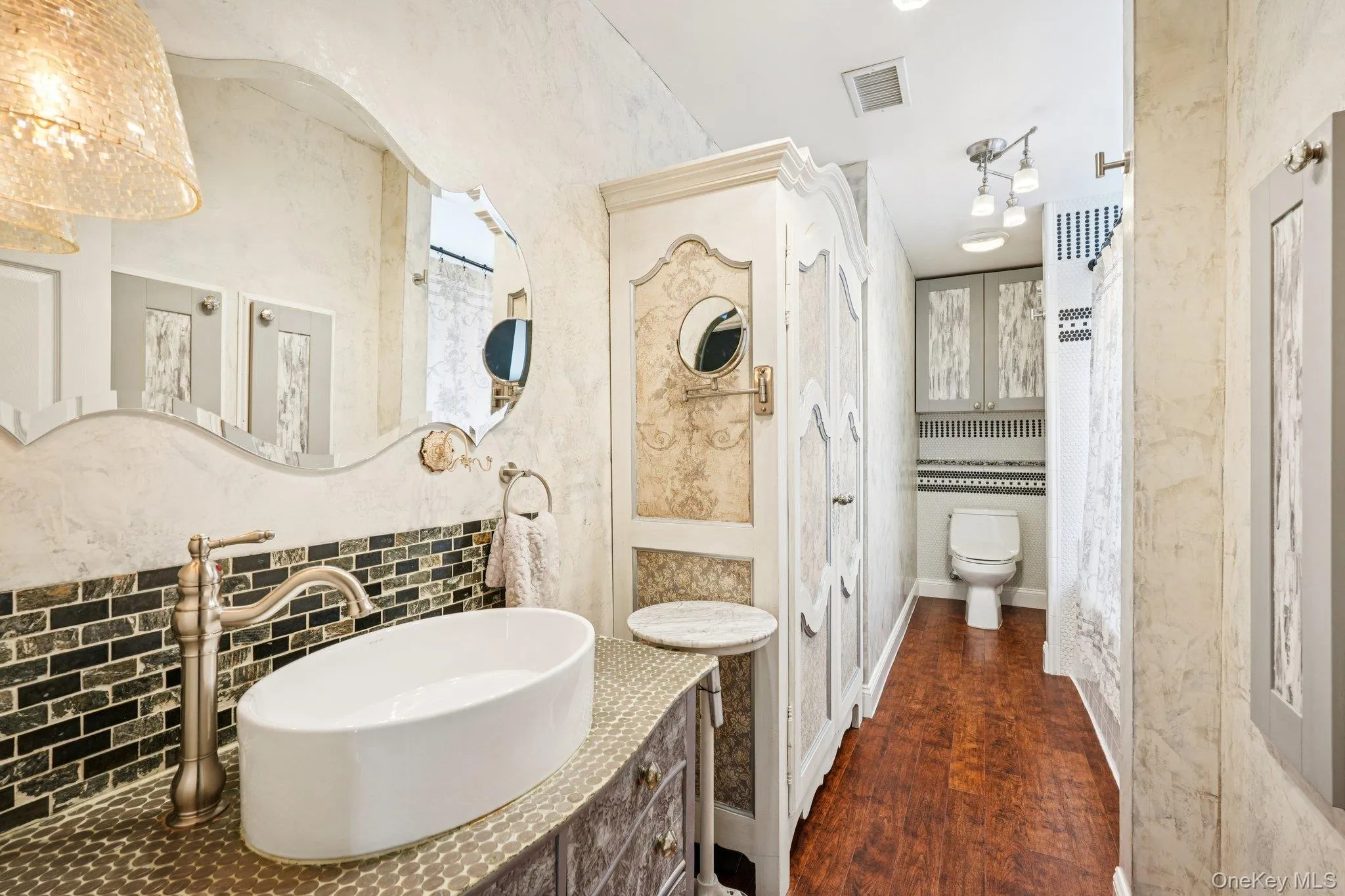 Full primary bath with double sinks (one hidden in tall chest) Full primary bath with double sinks (one hidden in tall chest)