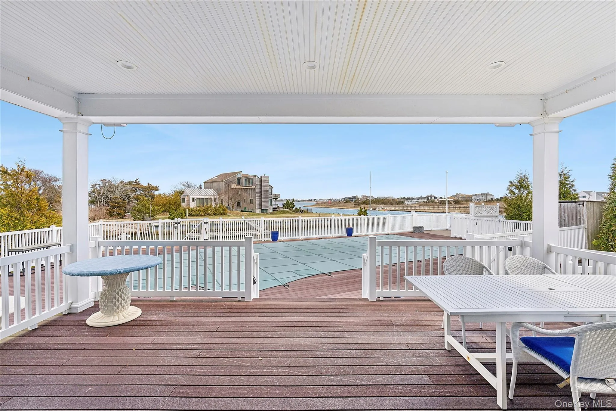 Covered Deck with Dining Area Overlooking Pool Covered Deck with Dining Area Overlooking Pool