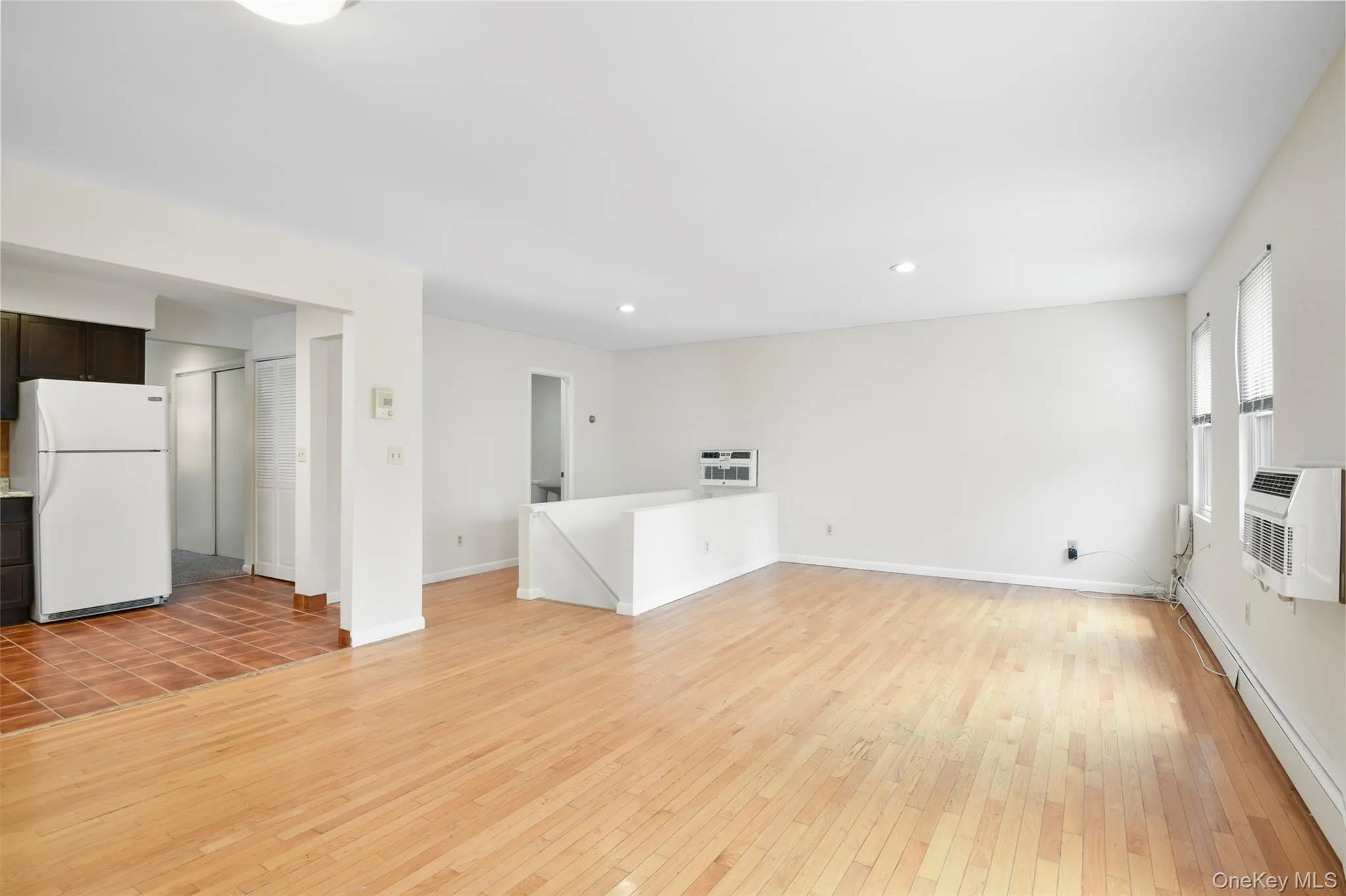 Open floor plan living room/dining area/kitchen. Beautiful hardwood floors. Open floor plan living room/dining area/kitchen. Beautiful hardwood floors.