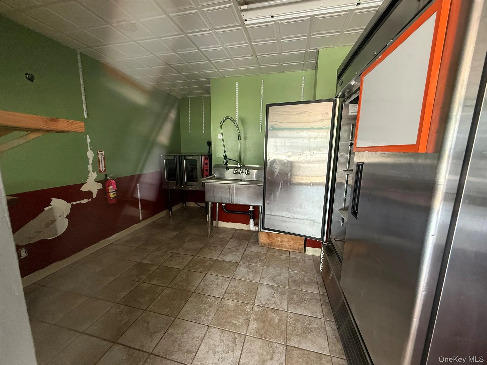 Kitchen with freestanding refrigerator and an ornate ceiling Kitchen with freestanding refrigerator and an ornate ceiling