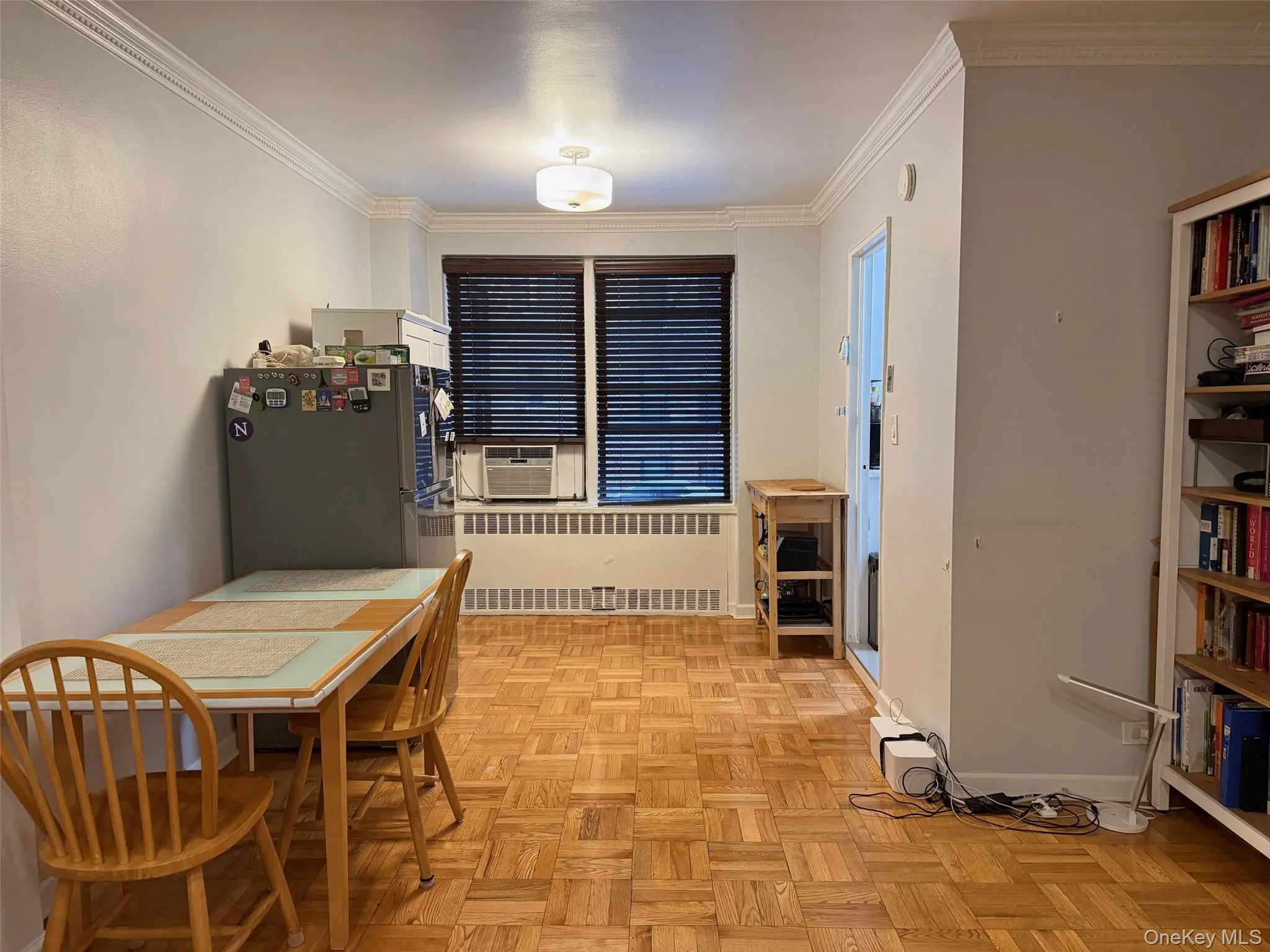 Hard wood floor throughout with crown molding with 2 windows Hard wood floor throughout with crown molding with 2 windows