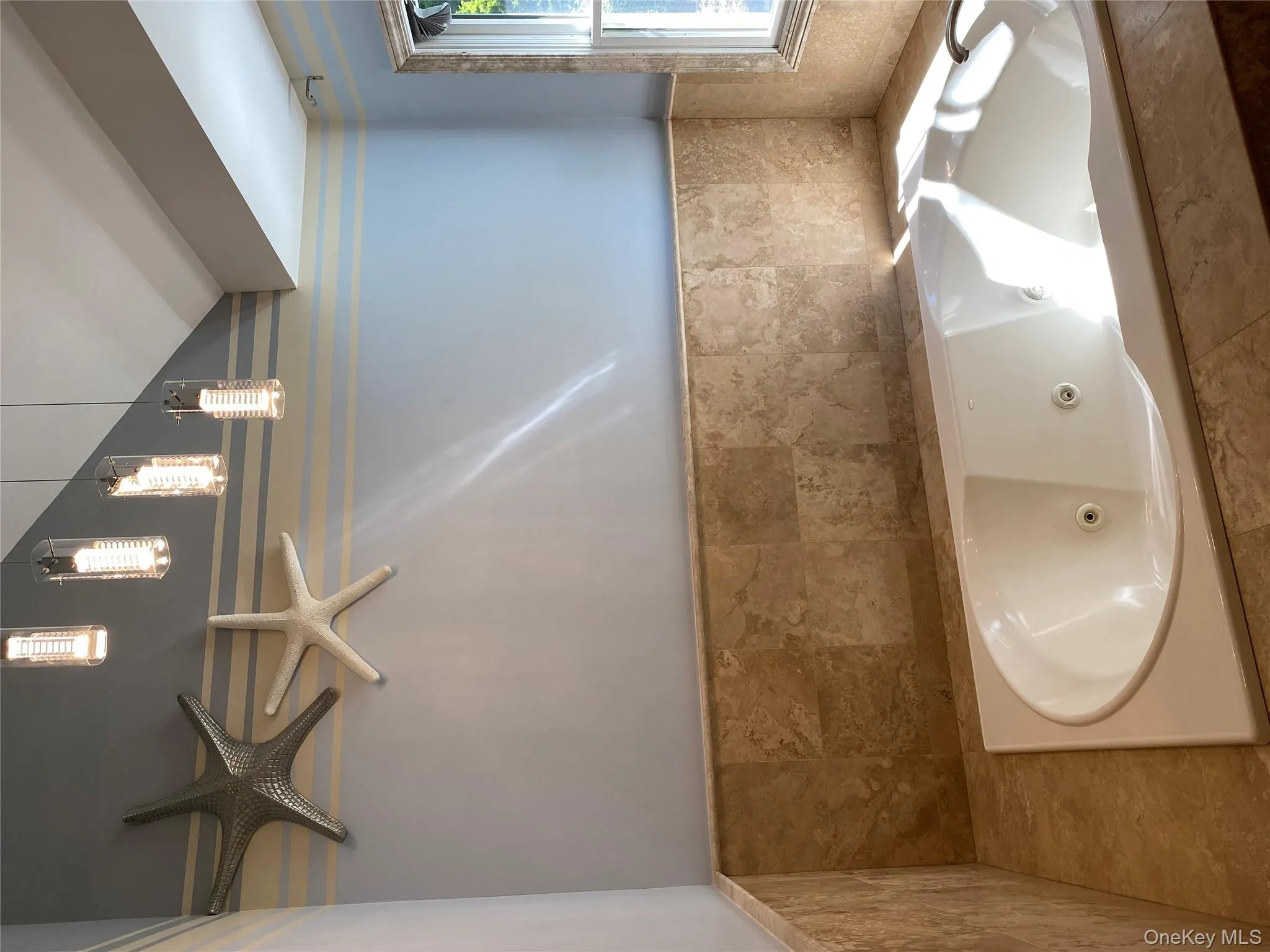 Bathtub in primary bathroom, all surrounded with travertine marble Bathtub in primary bathroom, all surrounded with travertine marble
