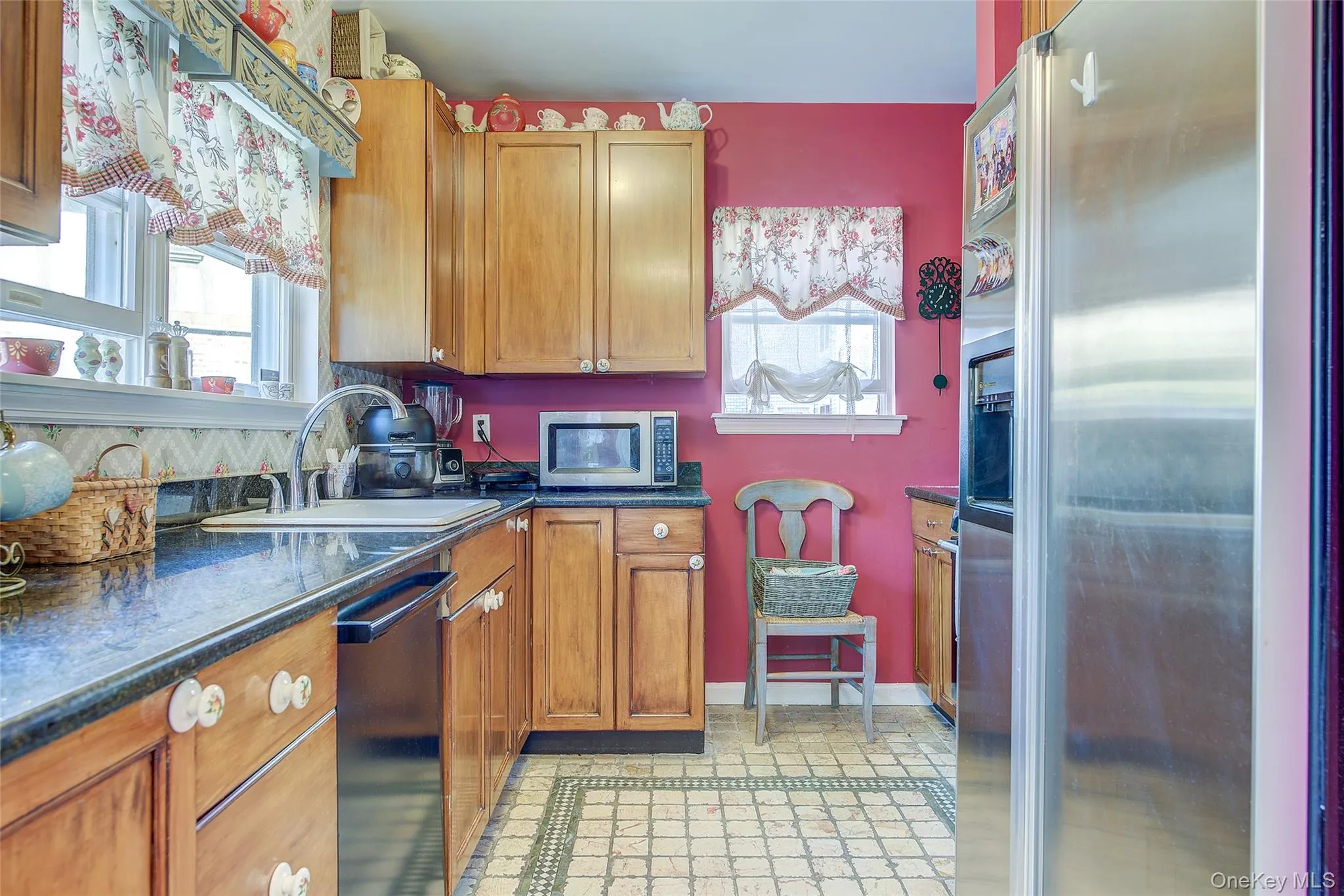 Kitchen with appliances with stainless steel finishes, brown cabinets, and healthy amount of natural light Kitchen with appliances with stainless steel finishes, brown cabinets, and healthy amount of natural light