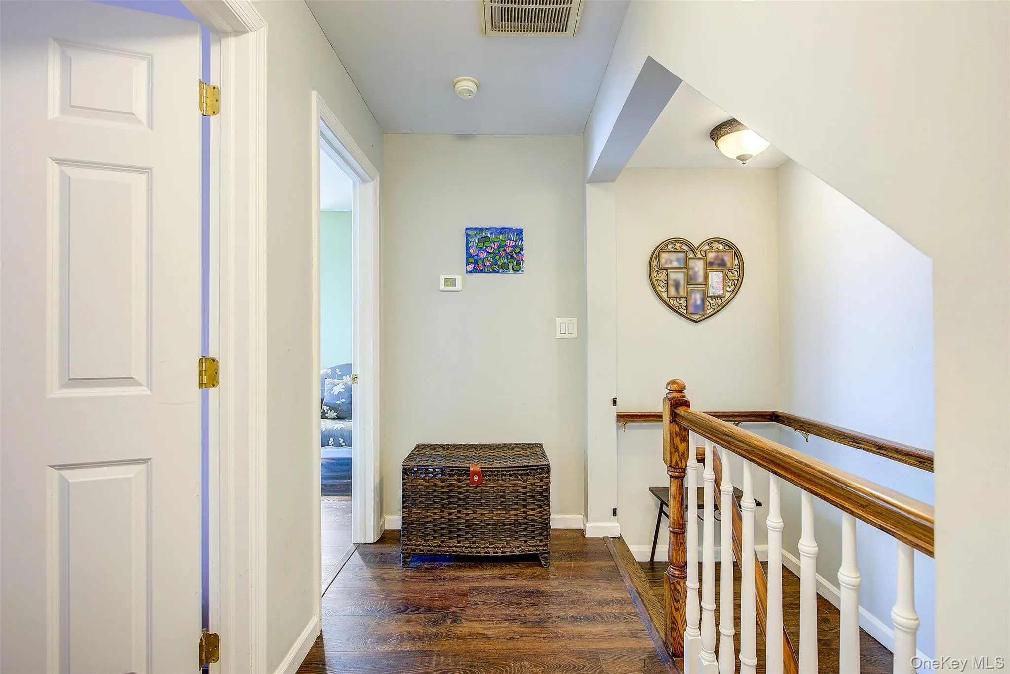 Hall with dark wood-style flooring and an upstairs landing Hall with dark wood-style flooring and an upstairs landing
