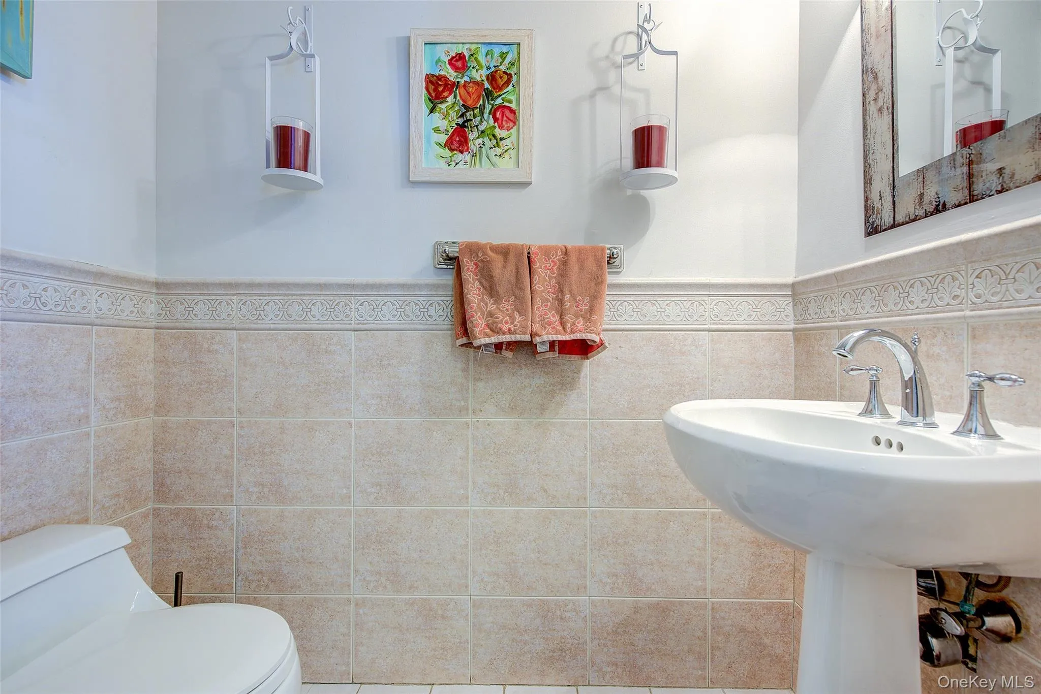Half bath featuring a wainscoted wall and tile walls Half bath featuring a wainscoted wall and tile walls