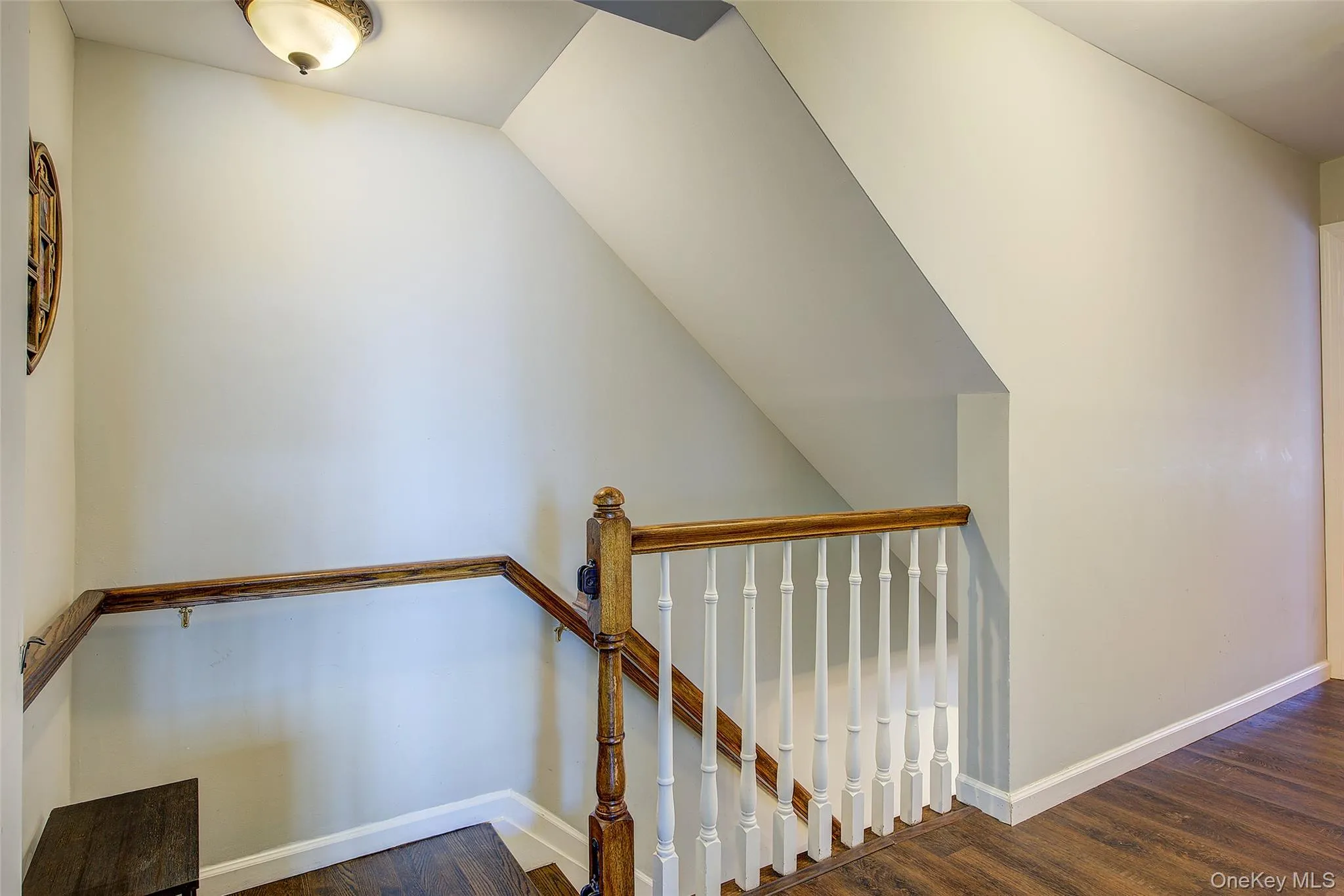 Stairway featuring baseboards and wood finished floors Stairway featuring baseboards and wood finished floors