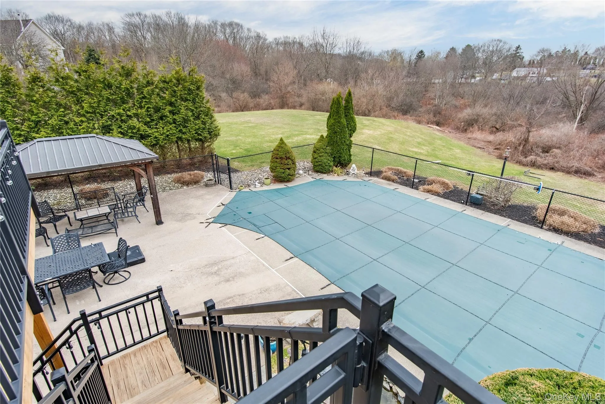 View of swimming pool with patio surround and a gazebo View of swimming pool with patio surround and a gazebo