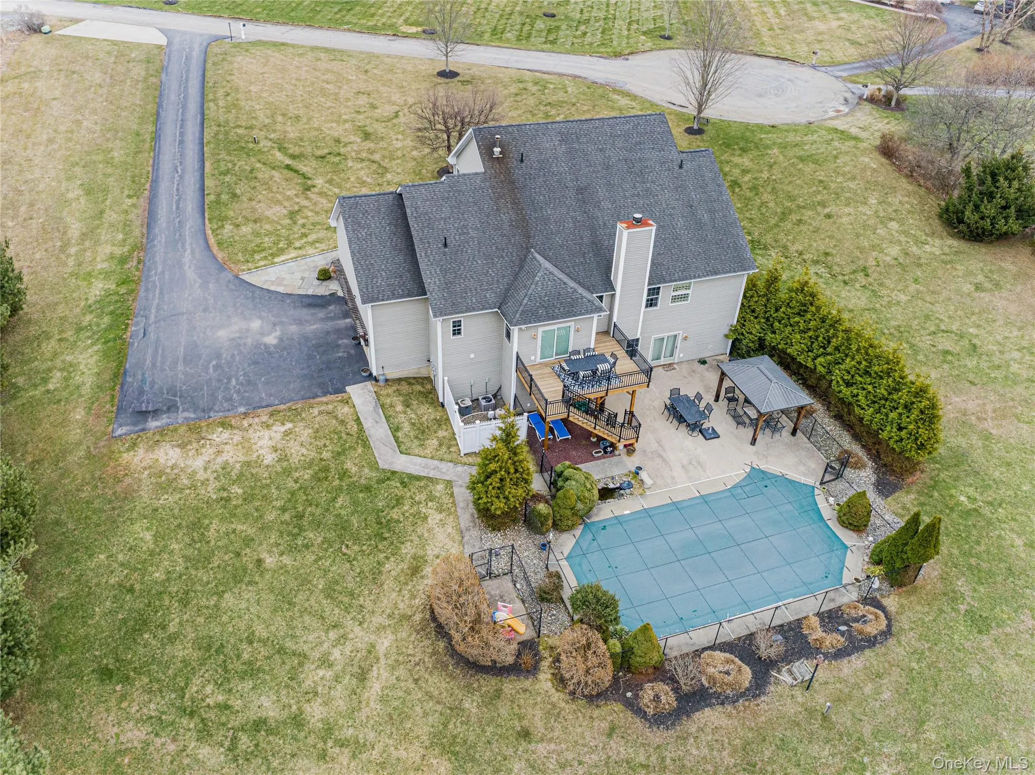Aerial view of property and surrounding area with a pool area Aerial view of property and surrounding area with a pool area