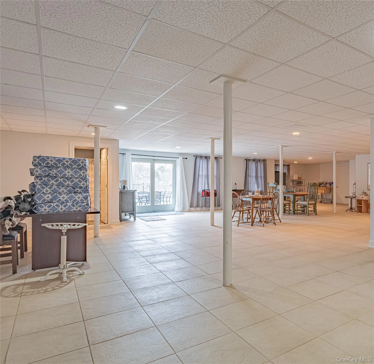 Below grade area (fninshed basement spcae) with a paneled ceiling and recessed lighting Below grade area (fninshed basement spcae) with a paneled ceiling and recessed lighting