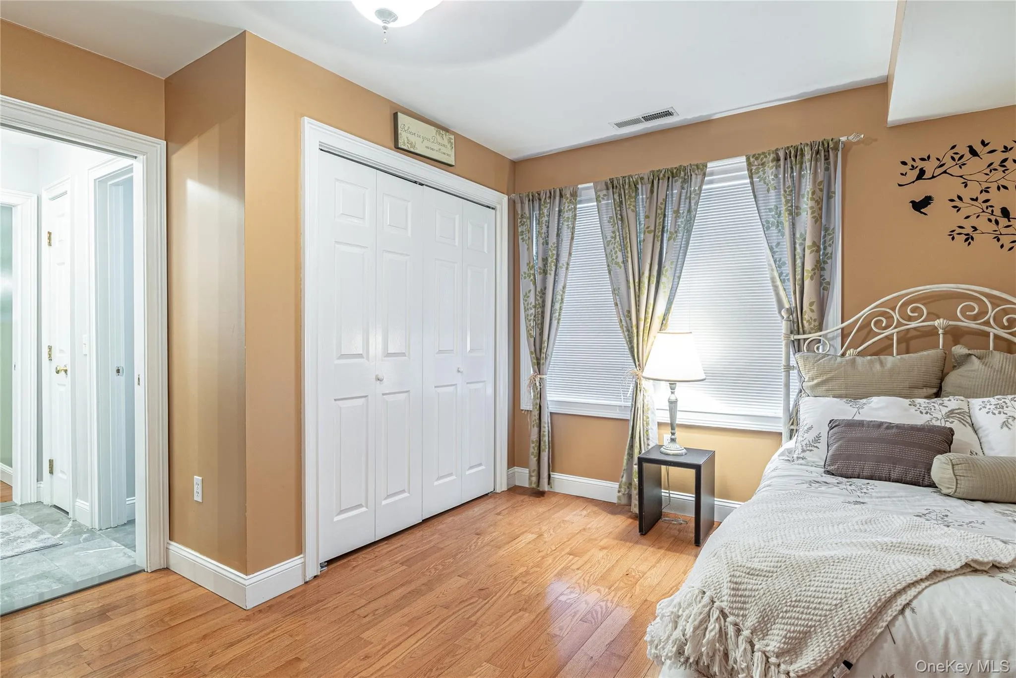 Bedroom with a closet and wood-style flooring Bedroom with a closet and wood-style flooring