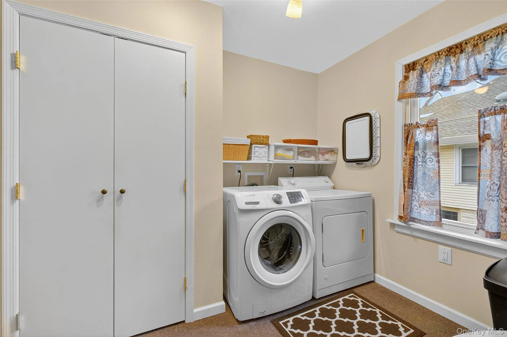 Washroom featuring washing machine and dryer and carpet flooring Washroom featuring washing machine and dryer and carpet flooring