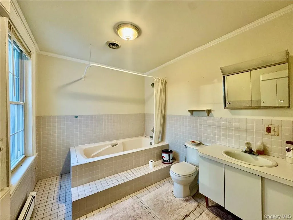 2nd floor Full bathroom with a baseboard radiator, tile walls, toilet, vanity, and tile patterned flooring 2nd floor Full bathroom with a baseboard radiator, tile walls, toilet, vanity, and tile patterned flooring