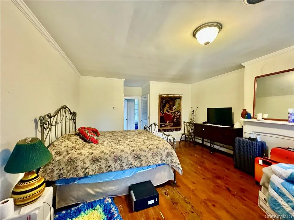 2nd floor Master Bedroom featuring ornamental molding and dark hardwood / wood-style floors 2nd floor Master Bedroom featuring ornamental molding and dark hardwood / wood-style floors