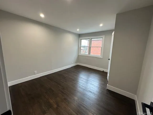 Bedroom with dark wood-type flooring and recessed lighting Bedroom with dark wood-type flooring and recessed lighting