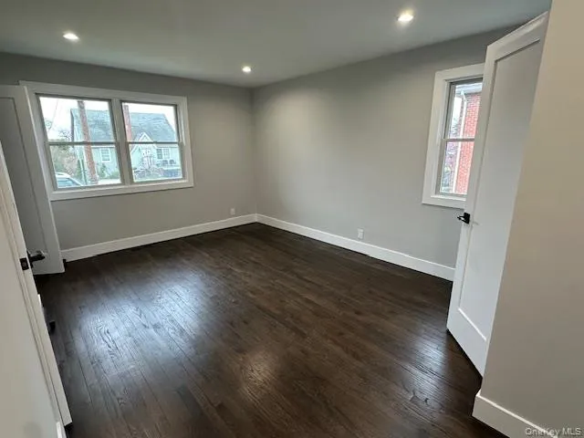 Bedroom with dark wood finished floors and recessed lighting Bedroom with dark wood finished floors and recessed lighting