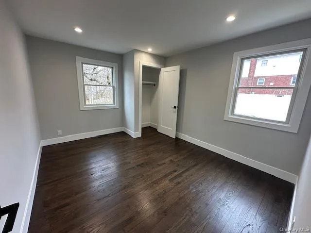 Bedroom featuring dark wood finished floors, a closet, and recessed lighting Bedroom featuring dark wood finished floors, a closet, and recessed lighting