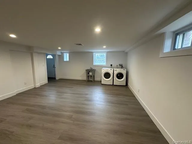 Laundry area with recessed lighting, dark wood finished floors, and washing machine and dryer Laundry area with recessed lighting, dark wood finished floors, and washing machine and dryer