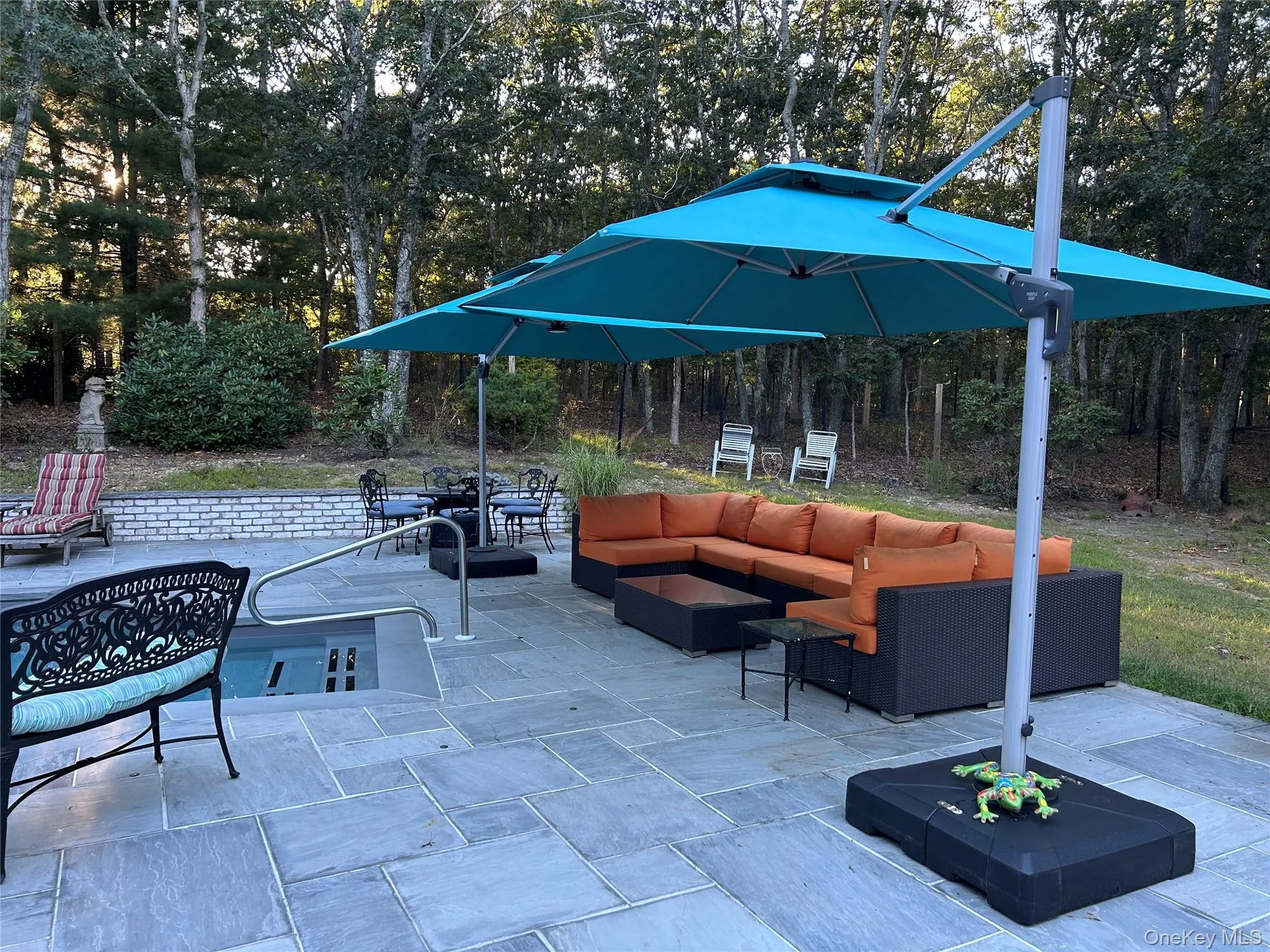 View of patio / terrace with outdoor lounge area and view of wooded area View of patio / terrace with outdoor lounge area and view of wooded area