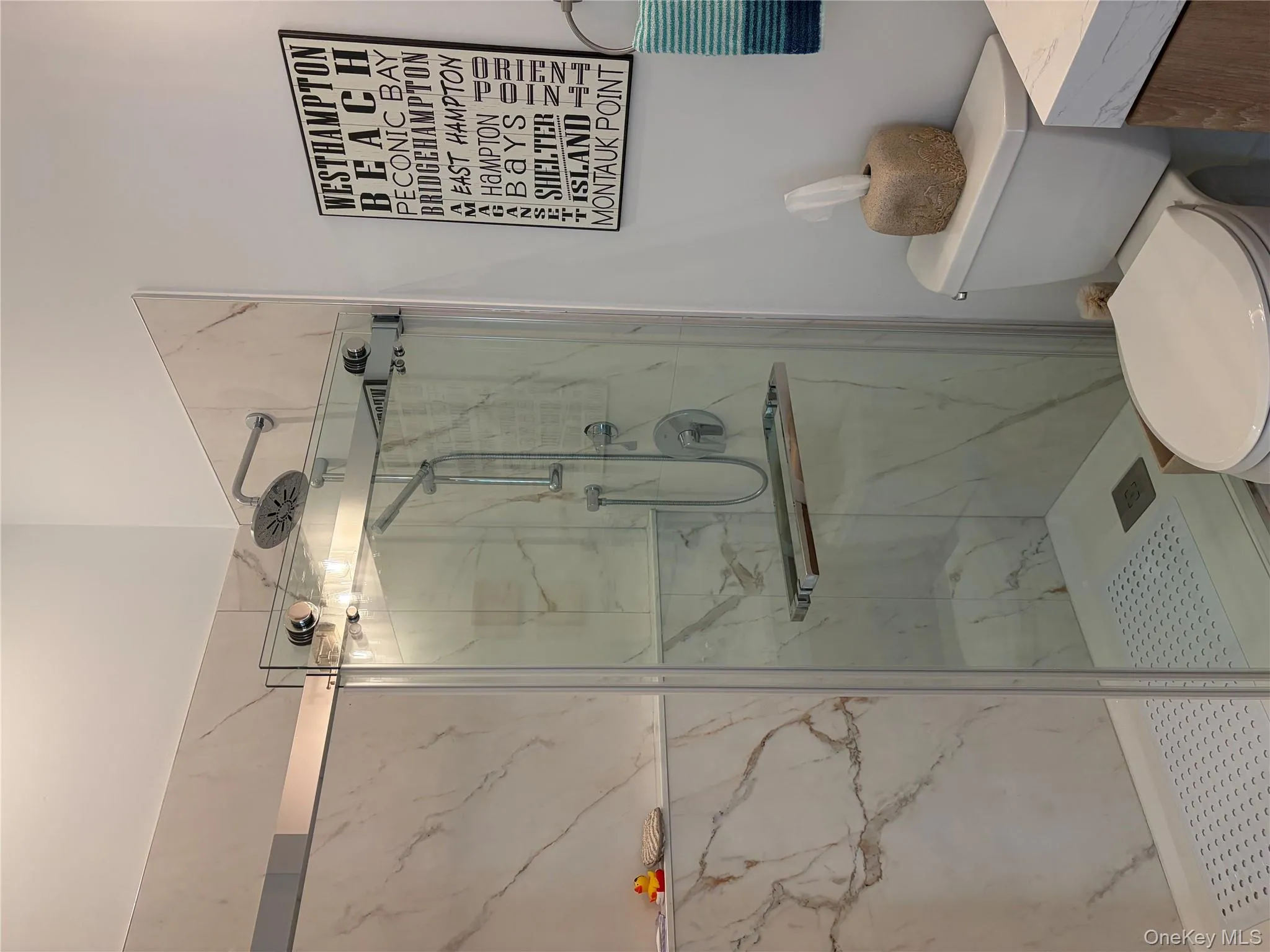 Bathroom with vanity and a marble finish shower Bathroom with vanity and a marble finish shower