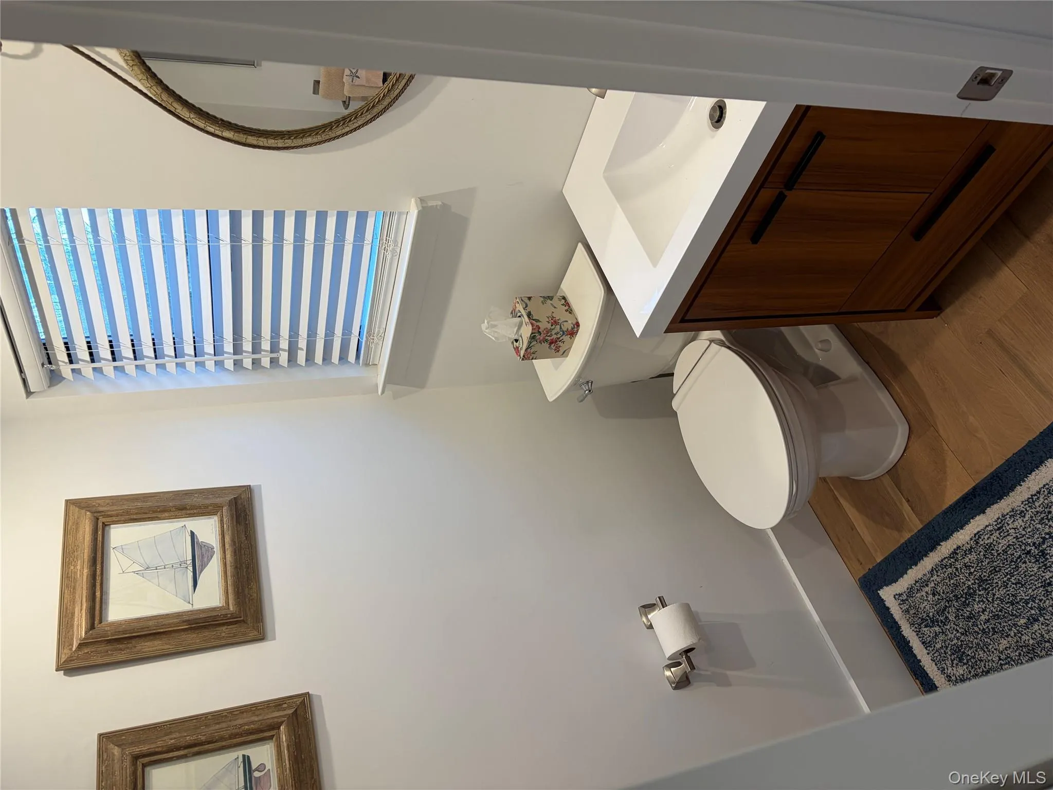 Bathroom with vanity and dark wood-style floors Bathroom with vanity and dark wood-style floors