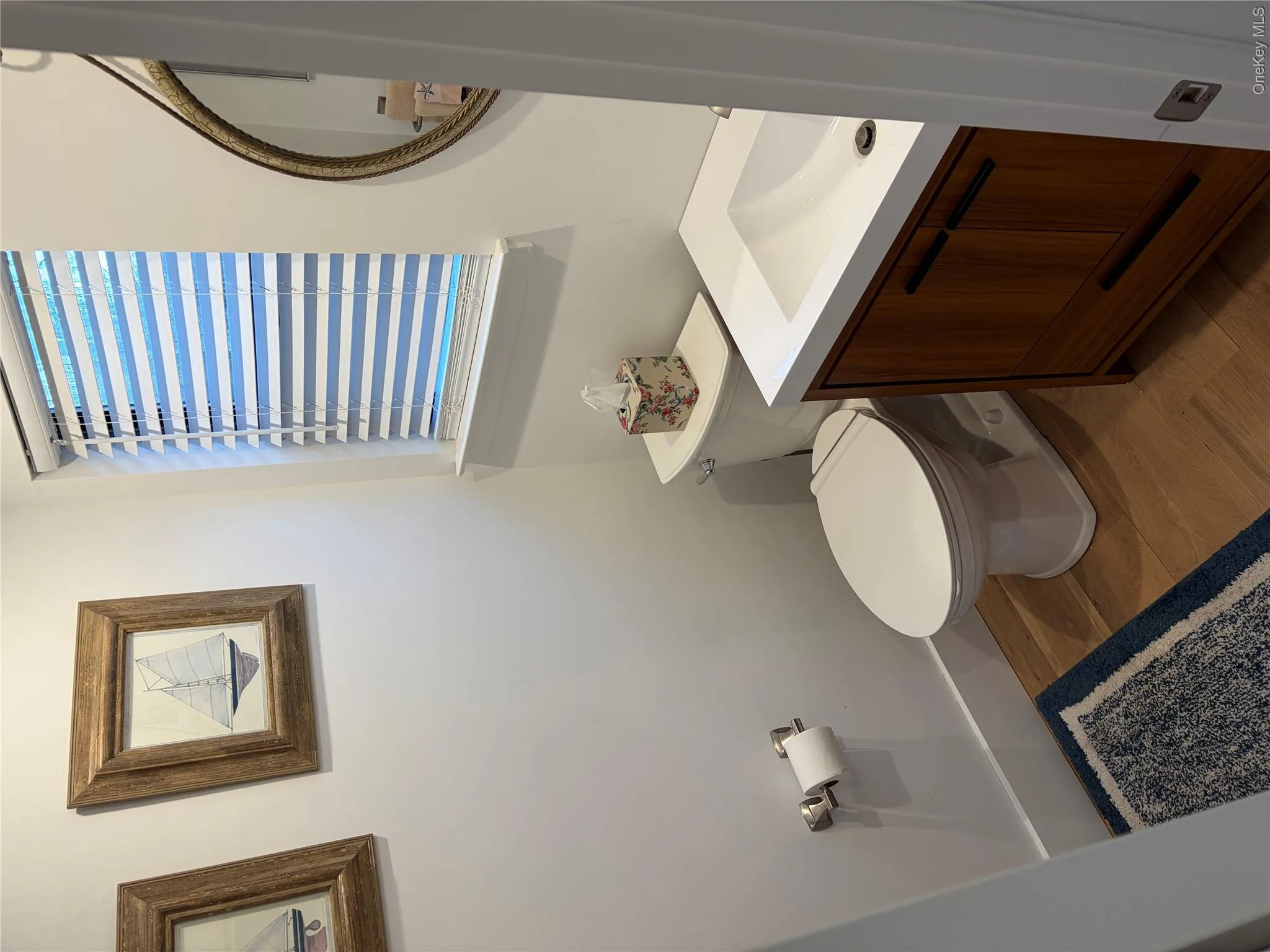 Bathroom with vanity and dark wood-style floors Bathroom with vanity and dark wood-style floors