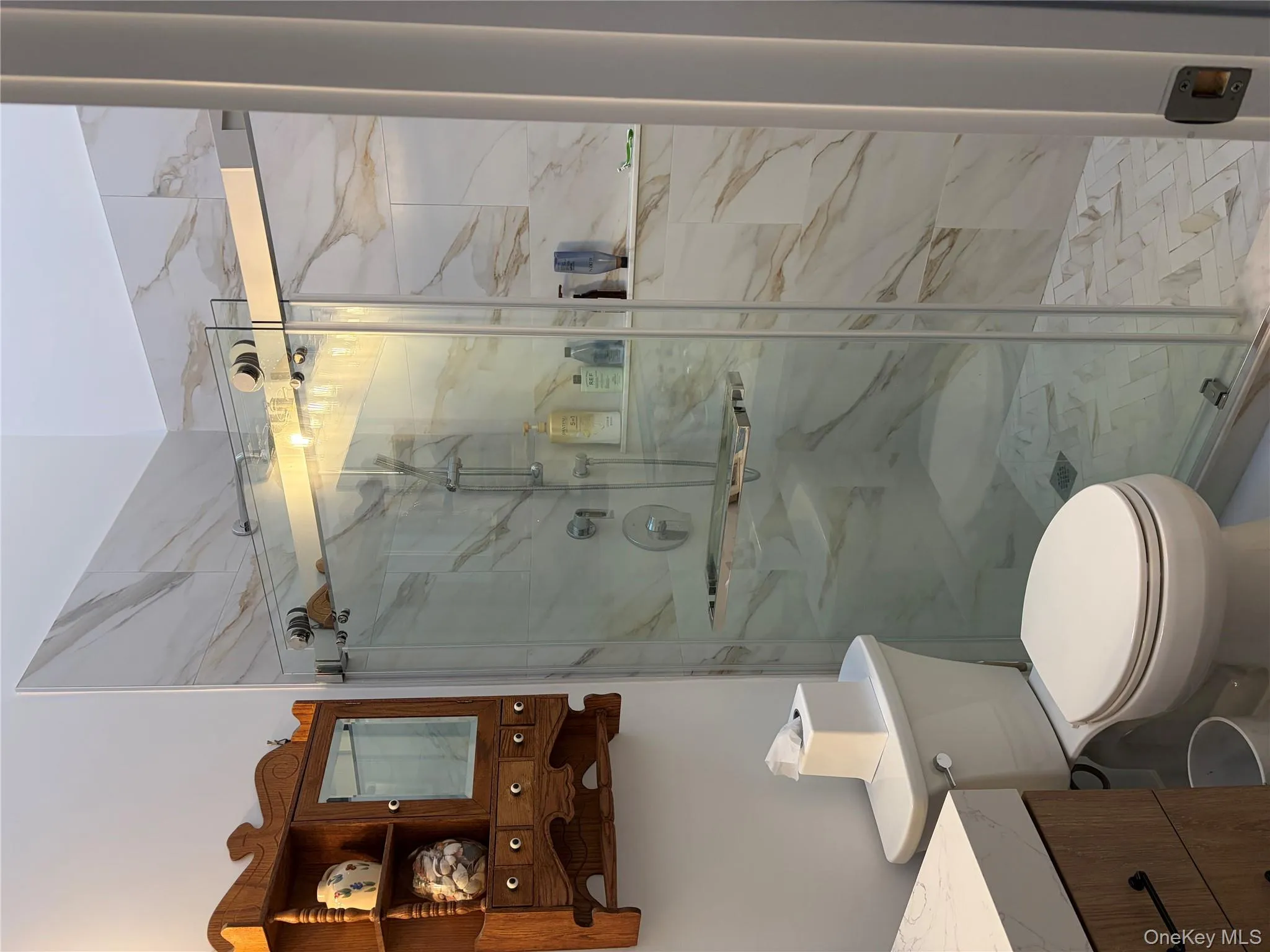 Bathroom with vanity and a marble finish shower Bathroom with vanity and a marble finish shower