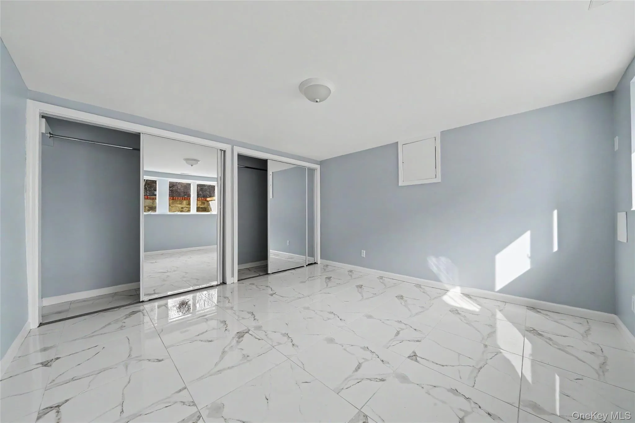 Master bedroom with two closets and light marble finish flooring Master bedroom with two closets and light marble finish flooring