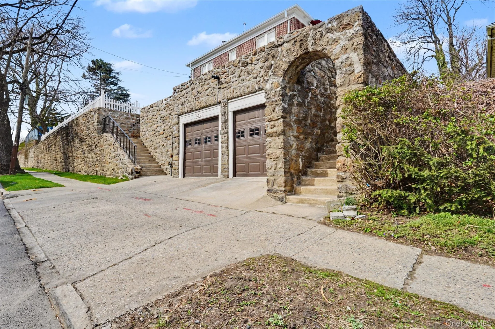 Private entrance of the property with stone siding and driveway Private entrance of the property with stone siding and driveway