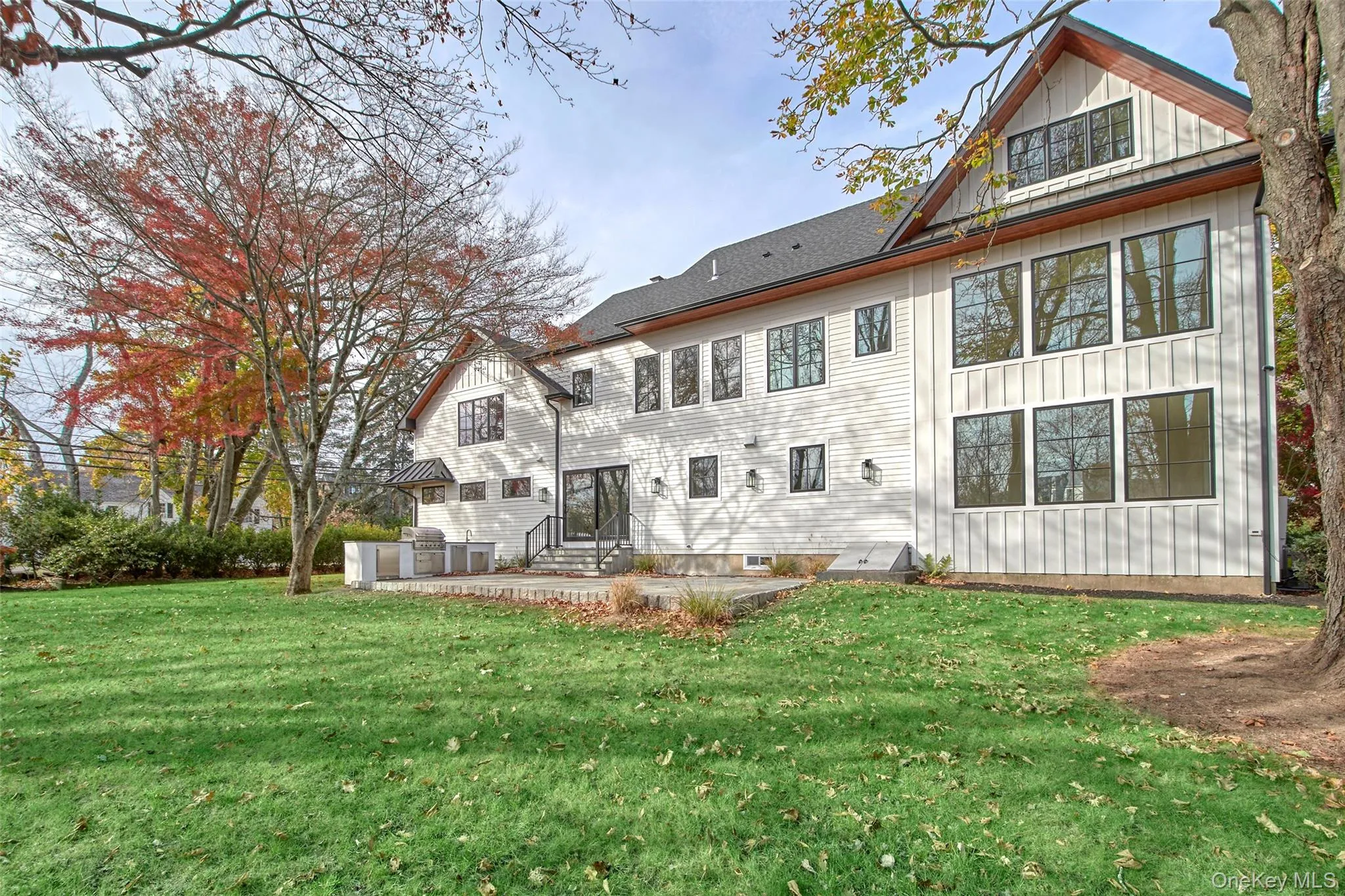 Rear view of property featuring a lawn Rear view of property featuring a lawn